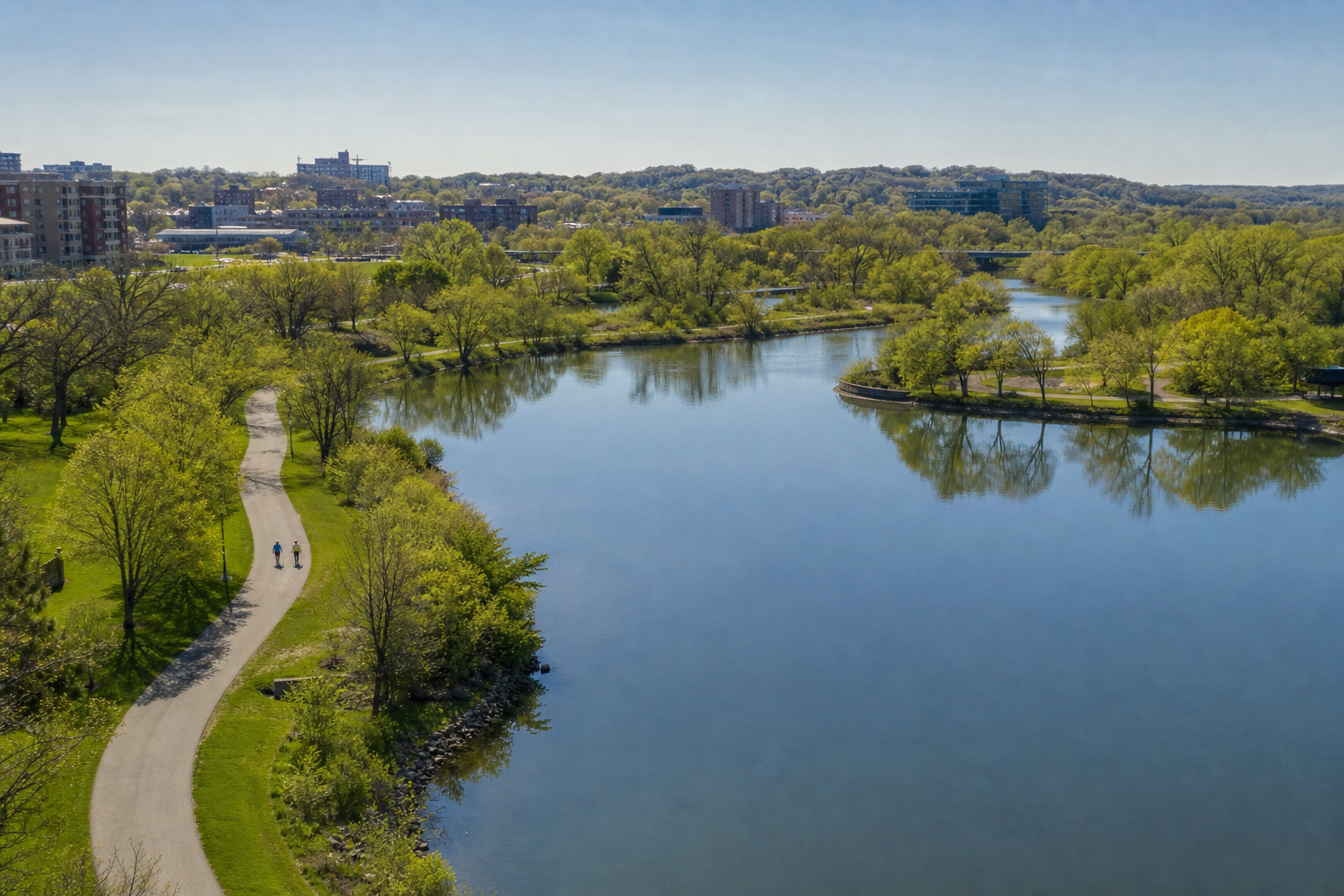 Illustrative elevated view of Rochester’s urban water corridor with a paved greenway and wooded hills