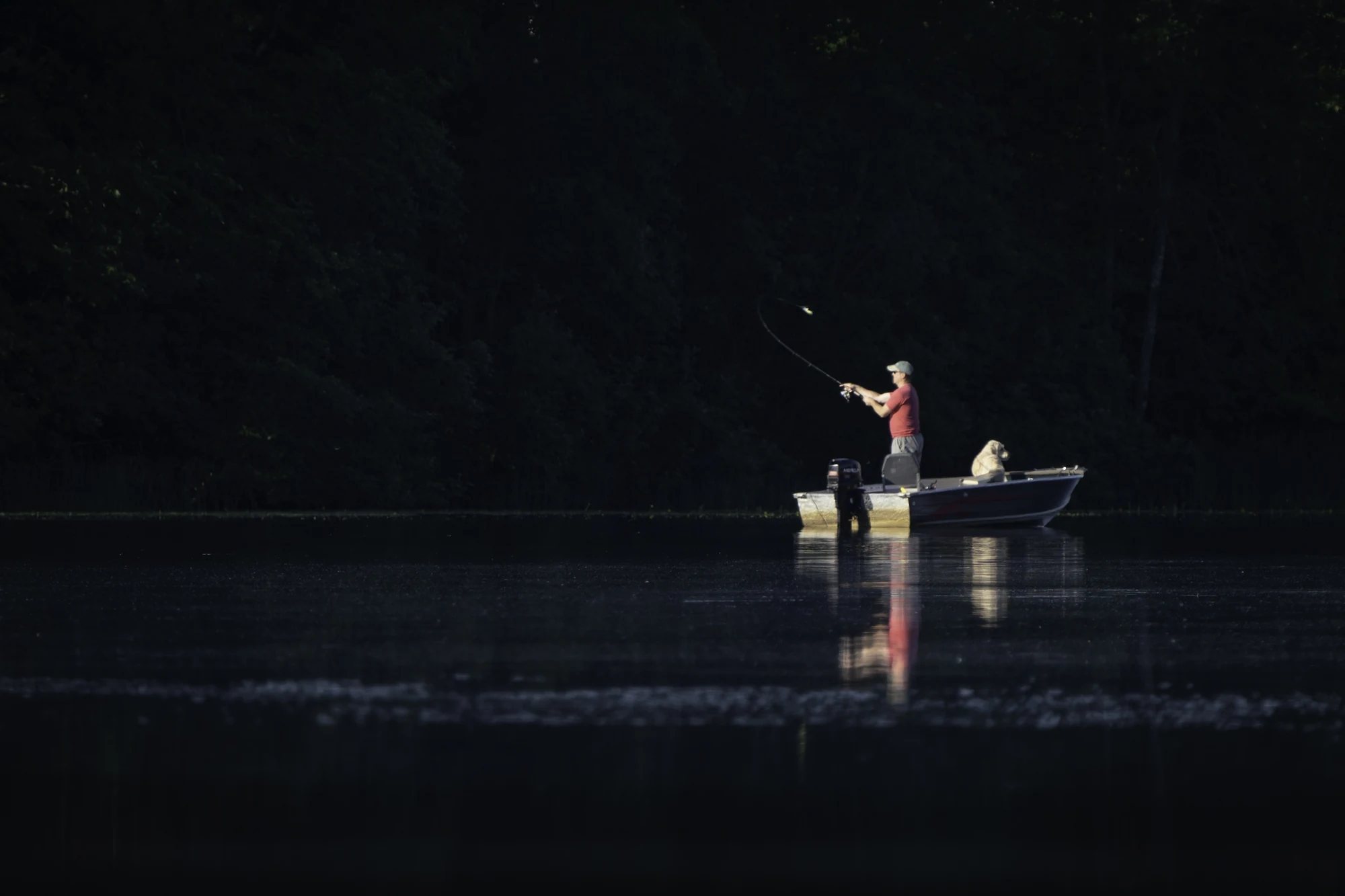Two people fish from a small boat on Lingroth Lake in Aitkin, Minnesota.