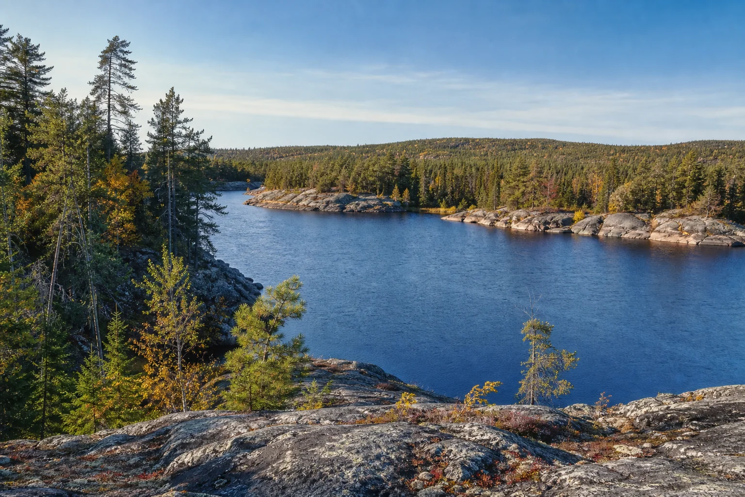 Illustrative Northeast Minnesota scene with rocky shore, conifers and open water.